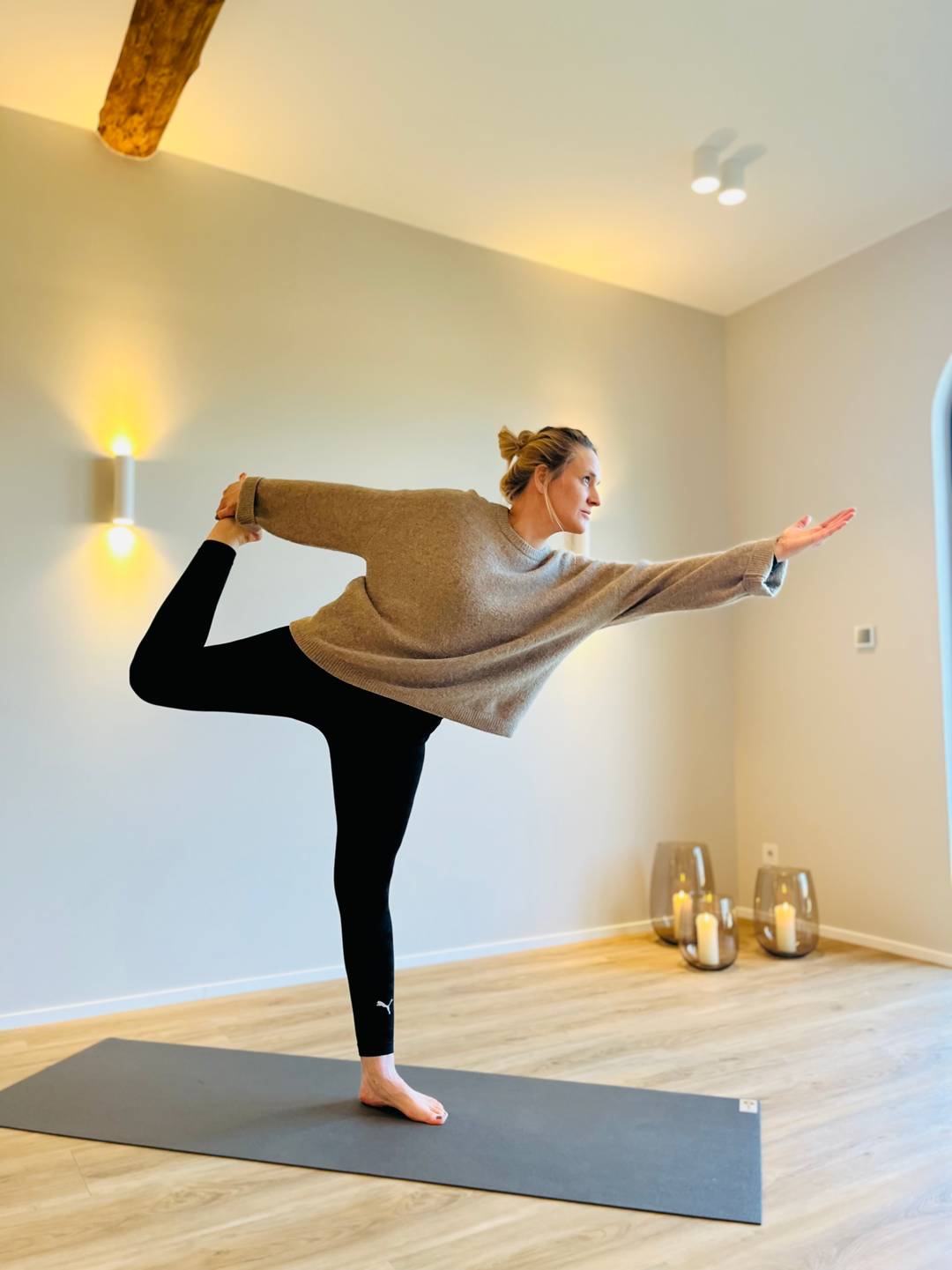 Eine junge Frau führt eine Yoga-Position aus